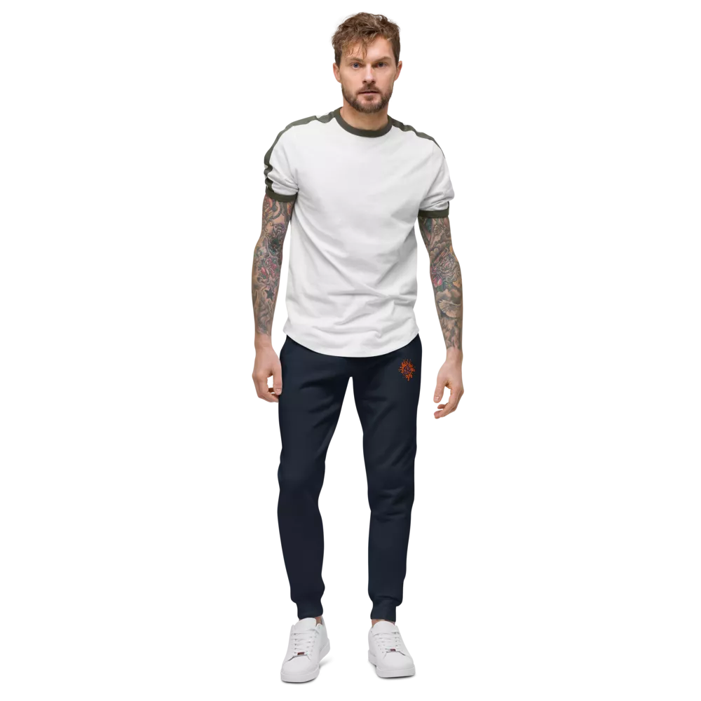 Man wearing a white t-shirt and navy tracksuit on a white background